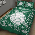 Green sea turtle quilt blanket styled on a bed with coral, shells, and starfish artwork