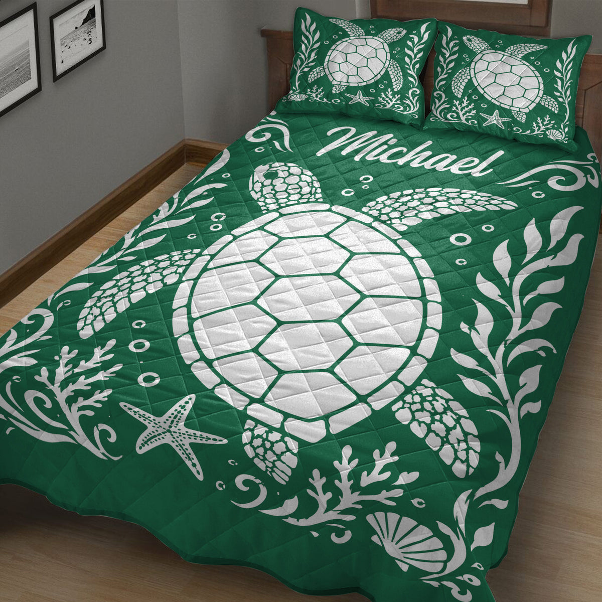 Green sea turtle quilt blanket styled on a bed with coral, shells, and starfish artwork