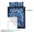 Sea turtle quilt showing the printed ocean artwork and quilted white backing