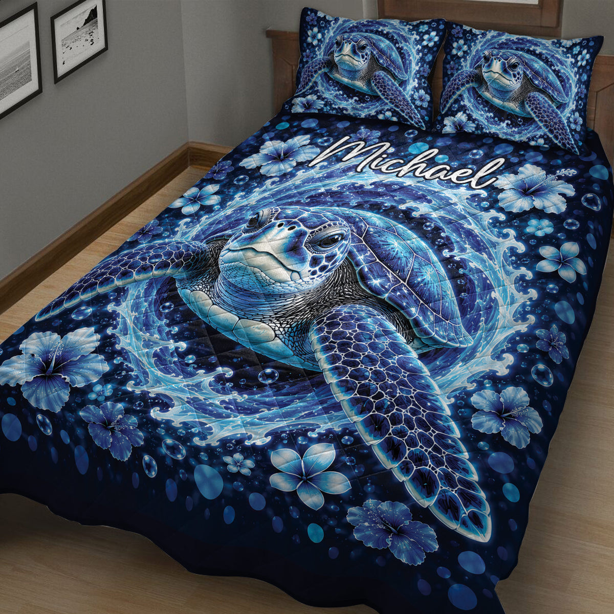 Close bedroom view of a blue sea turtle quilt with waves, bubbles, and tropical flowers