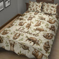 Close bedroom view of a sloth quilt blanket featuring playful wildlife artwork on a cream background