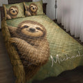 Sloth quilt blanket styled on a bed with matching sloth artwork and earthy green bedroom decor