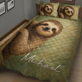 Close bedroom view of a sloth quilt blanket with earthy green tones and playful sloth artwork