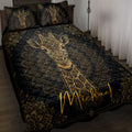 Black and gold giraffe quilt blanket displayed on a bed with matching giraffe pillow designs
