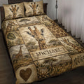 Giraffe quilt blanket displayed on a bed with savanna scenery, foliage, and warm earth-tone artwork