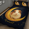 Close bedroom view of a guinea pig quilt blanket with golden moon artwork on a dark starry background