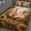 Close view of a pig quilt blanket with sunflower borders and rustic barrel artwork
