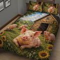 Farm pig quilt blanket displayed on a bed with piglets, sunflowers, meadow, and rustic barn artwork