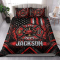 Firefighter quilt blanket styled on a bedroom bed with bold fire department emblem and red-black artwork