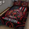 Close bedroom view of firefighter quilt blanket with helmet, axes, ladder, hydrant, flames, and fire department emblem