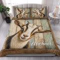 Goat quilt blanket styled in a bright bedroom with large animal artwork and rustic tones