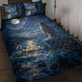 Mermaid quilt bedding set displayed on a bed with moonlit ocean artwork in deep blue tones