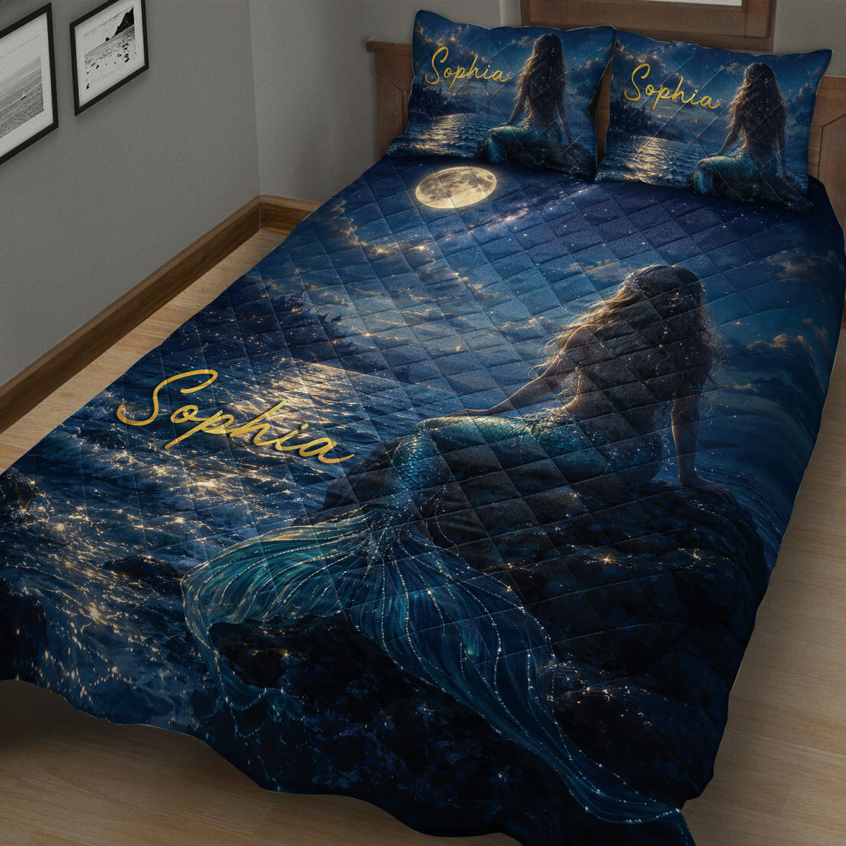 Close bedroom view of a dark blue mermaid quilt with shimmering water, moonlight and ocean artwork