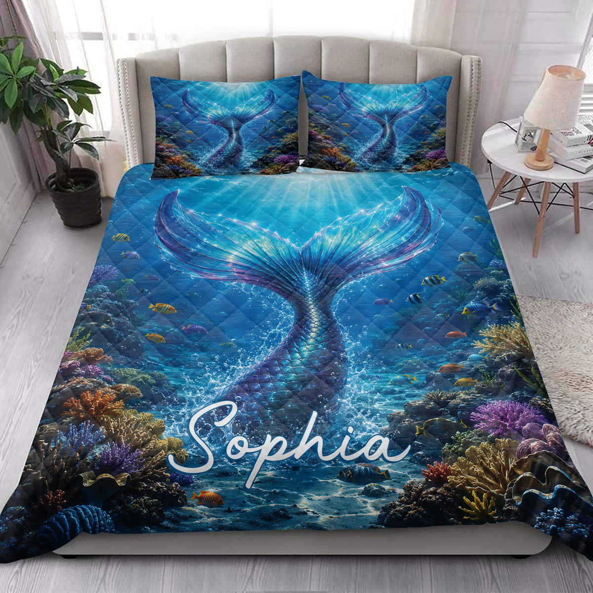 Mermaid quilt blanket styled in a bright bedroom with a large underwater tail and colorful reef design