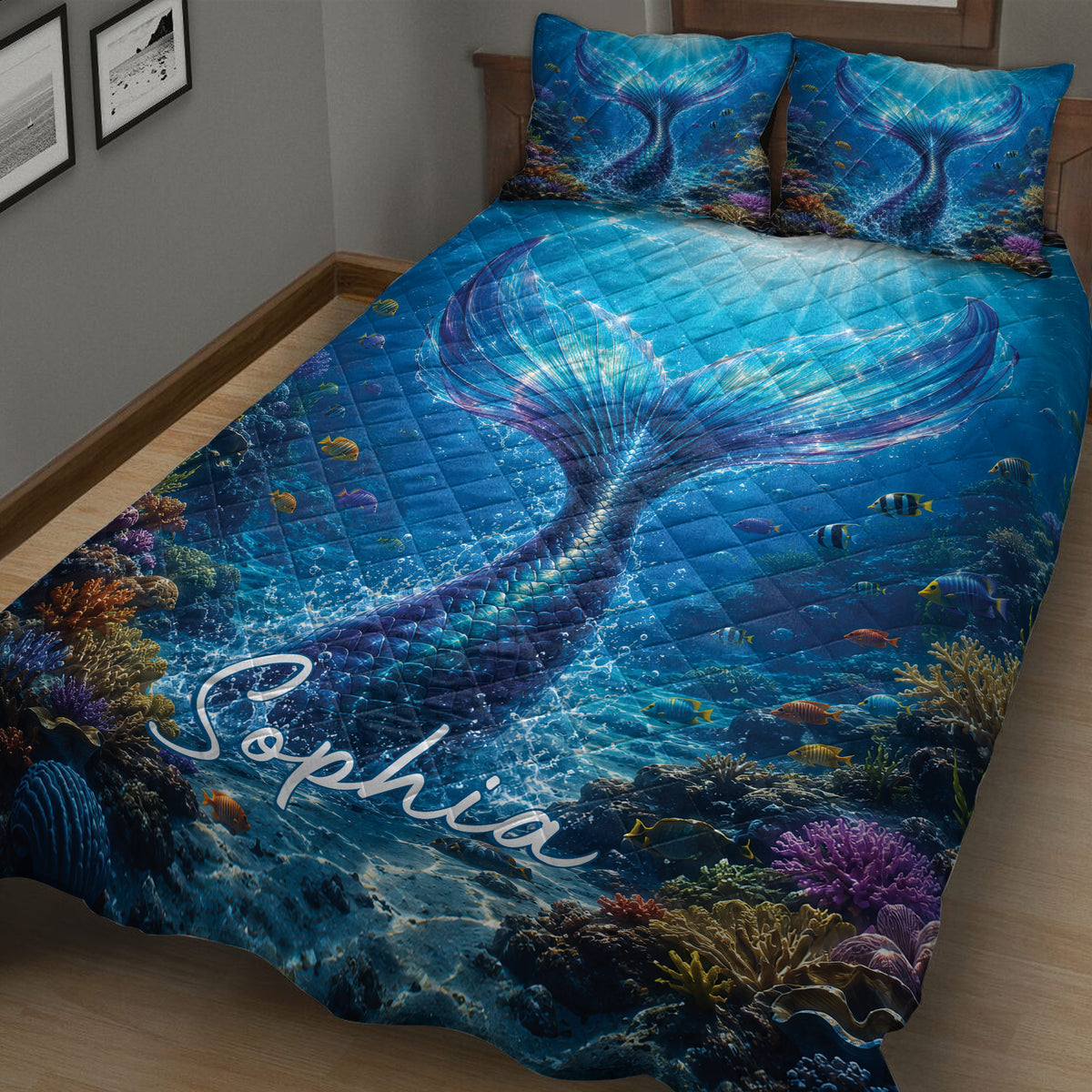 Close view of mermaid tail quilt blanket bedding with blue ocean water, tropical fish, and coral reef artwork