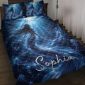 Blue mermaid quilt blanket displayed on a bed with underwater waves, jellyfish, bubbles, and ocean details