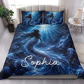 Blue mermaid quilt bedding styled in a bright bedroom with ocean waves, jellyfish, and underwater artwork
