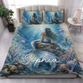 Mermaid quilt blanket styled in a bright bedroom with underwater coral and sea life artwork