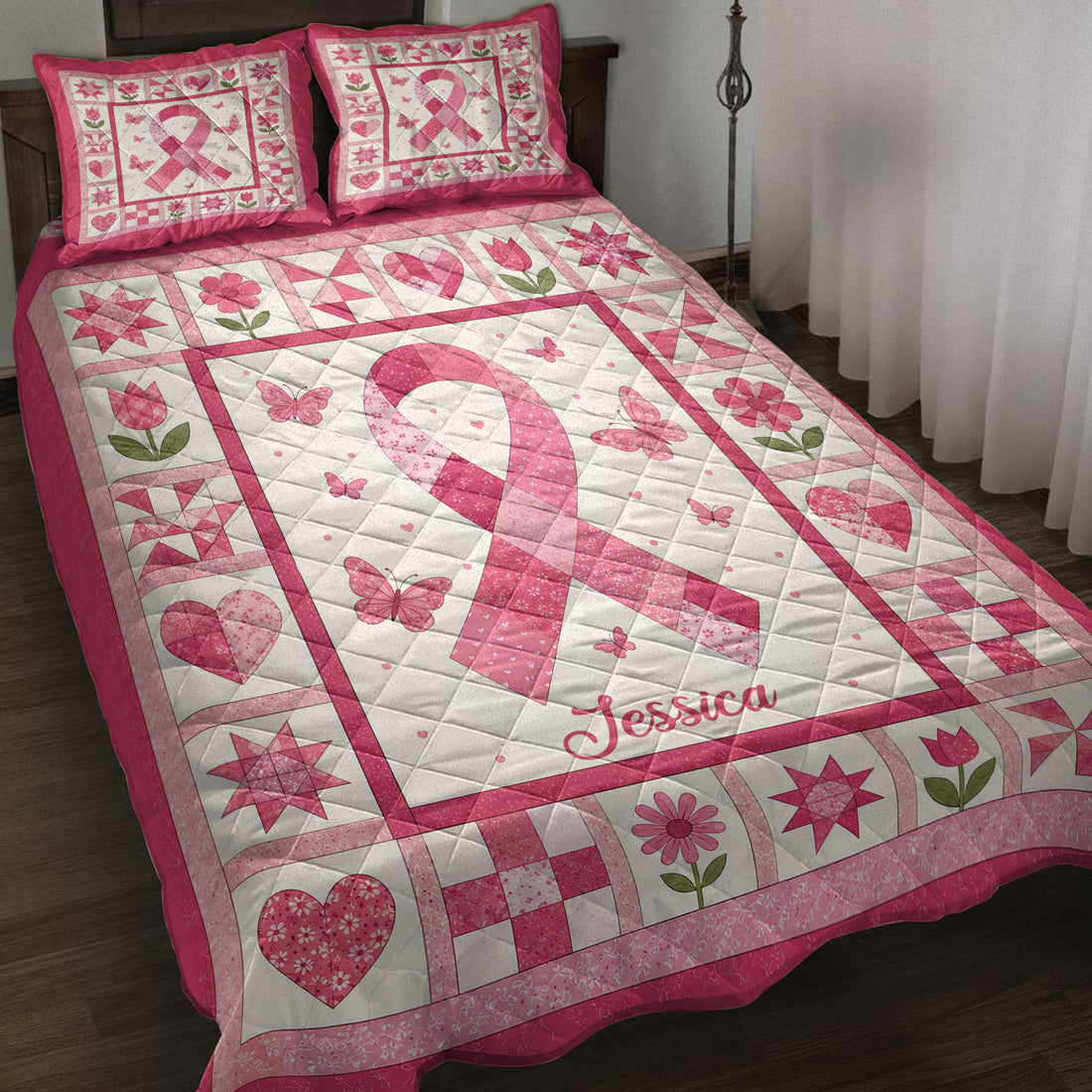 Pink breast cancer awareness ribbon quilt blanket displayed on a bed with floral and butterfly patchwork