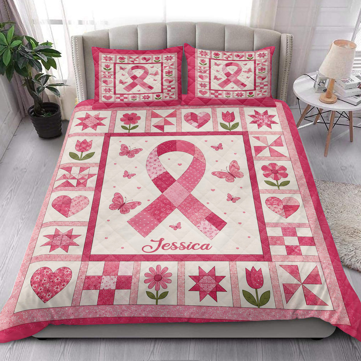 Pink breast cancer awareness quilt blanket styled on a bedroom bed with matching ribbon artwork