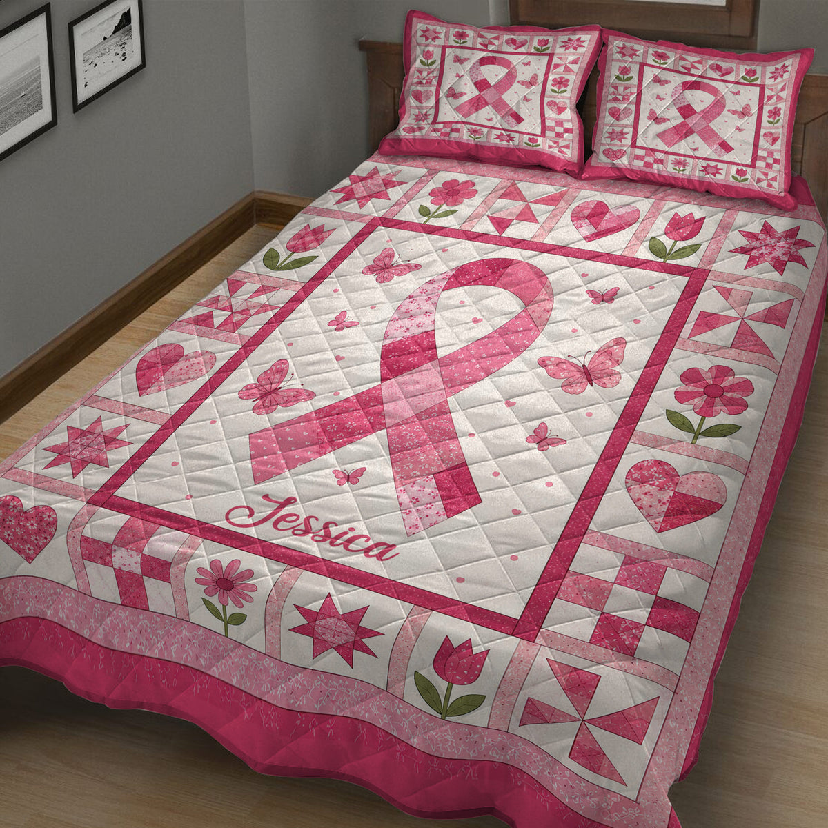 Close view of a pink breast cancer ribbon quilt blanket with butterflies, flowers, hearts, and patchwork borders