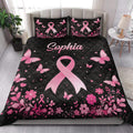 Breast cancer awareness quilt blanket styled on a bed with pink ribbons, butterflies, and floral borders