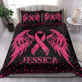 Pink breast cancer awareness quilt blanket styled on a bright bedroom bed with matching ribbon artwork