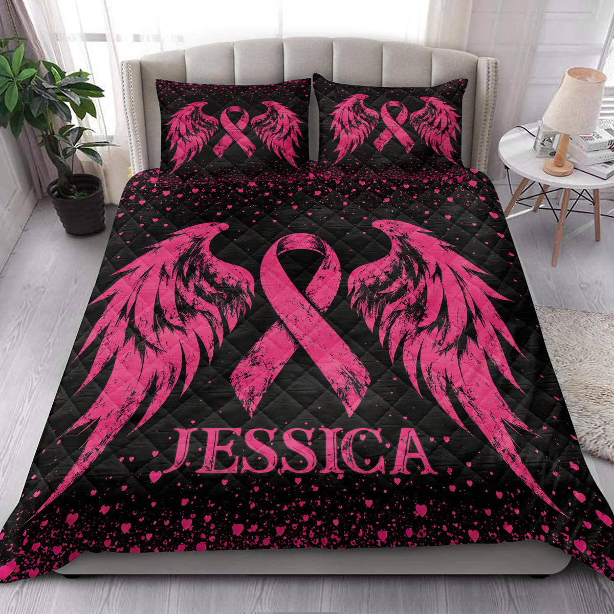 Pink breast cancer awareness quilt blanket styled on a bright bedroom bed with matching ribbon artwork