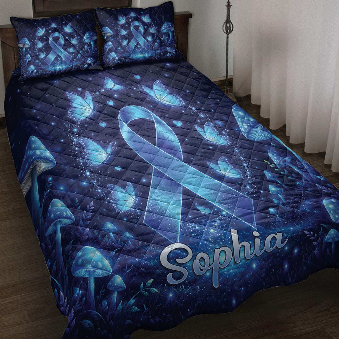 Diabetes awareness quilt blanket displayed on a bed with blue ribbons, butterflies, mushrooms, stars, and hearts