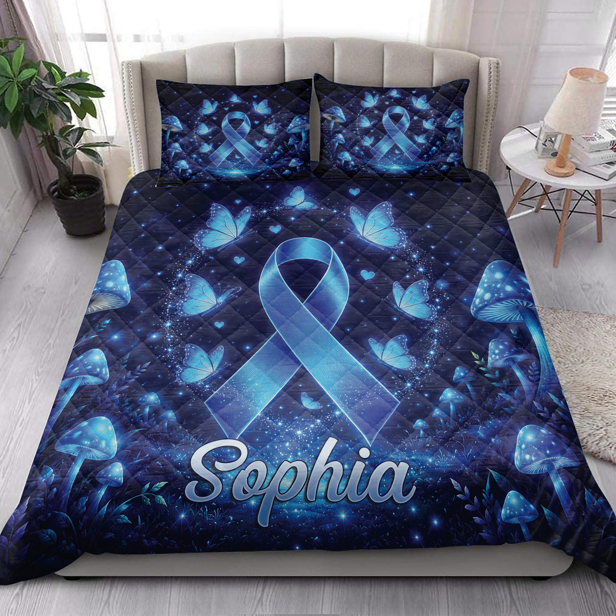 Diabetes awareness quilt blanket styled in a bright bedroom with blue ribbons, butterflies, and mushroom artwork