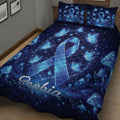 Close bedroom view of a diabetes awareness quilt with a large blue ribbon, butterflies, stars, and mushrooms