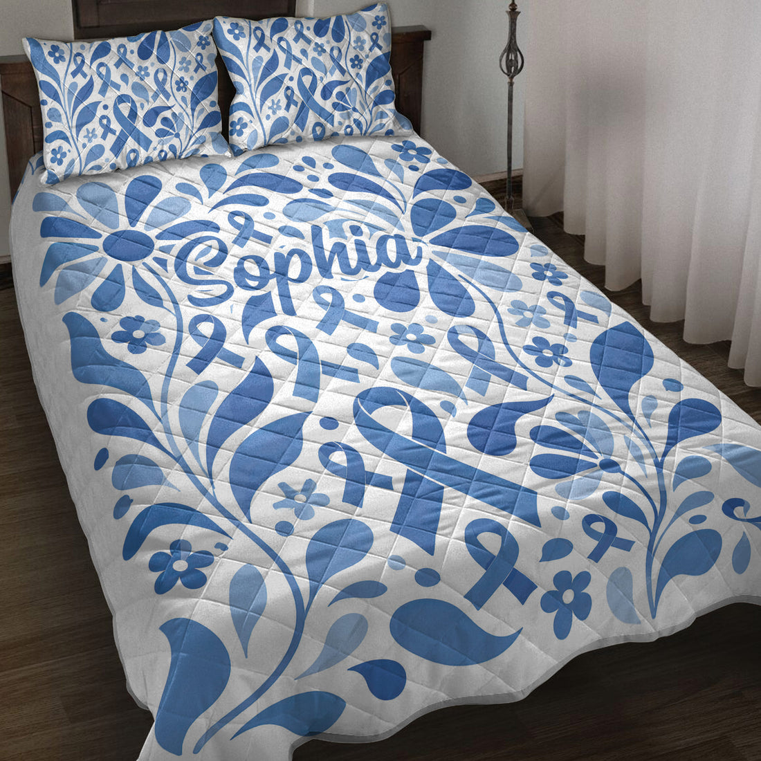 Blue diabetes awareness ribbon quilt blanket with floral artwork styled on a bedroom bed