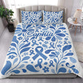 Blue diabetes awareness ribbon quilt blanket displayed in a bright modern bedroom