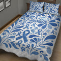 Close bedroom view of a blue diabetes awareness quilt blanket with floral ribbon artwork