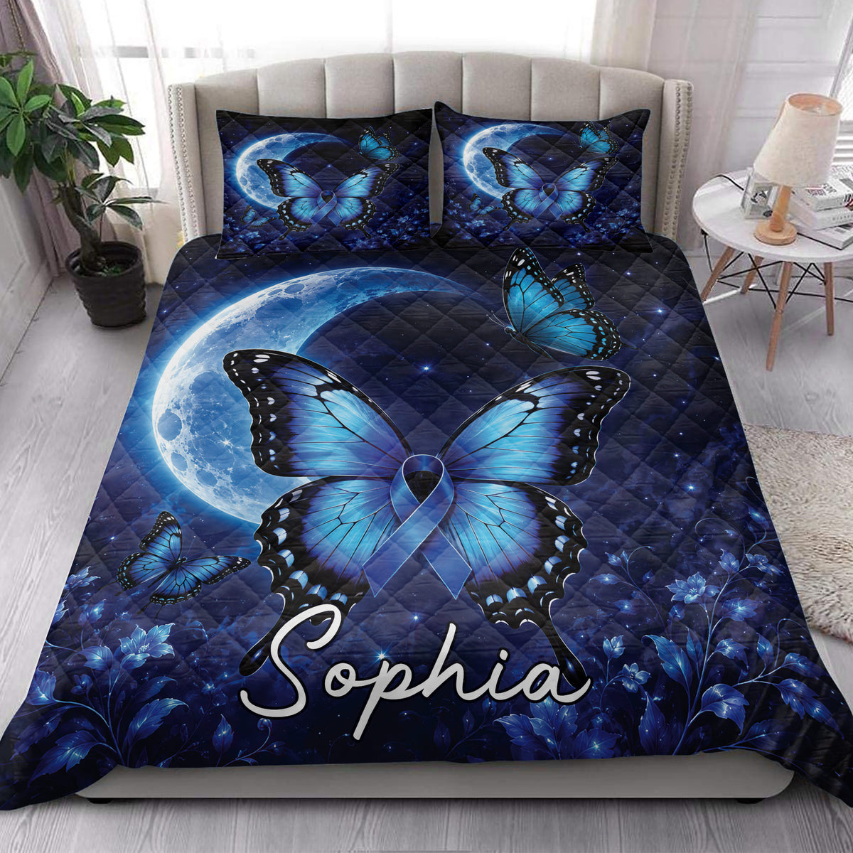 Diabetes awareness butterfly quilt styled on a bright bedroom bed with matching blue artwork
