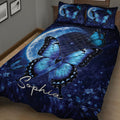 Close bedroom view of a dark blue diabetes awareness quilt with butterflies, moon, and floral details