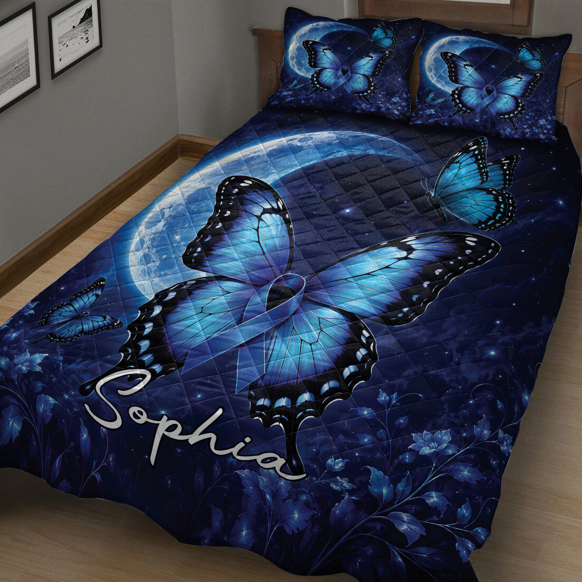 Close bedroom view of a dark blue diabetes awareness quilt with butterflies, moon, and floral details
