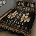Angled bedroom view of a black alpaca quilt with geometric motifs and leafy decorative borders