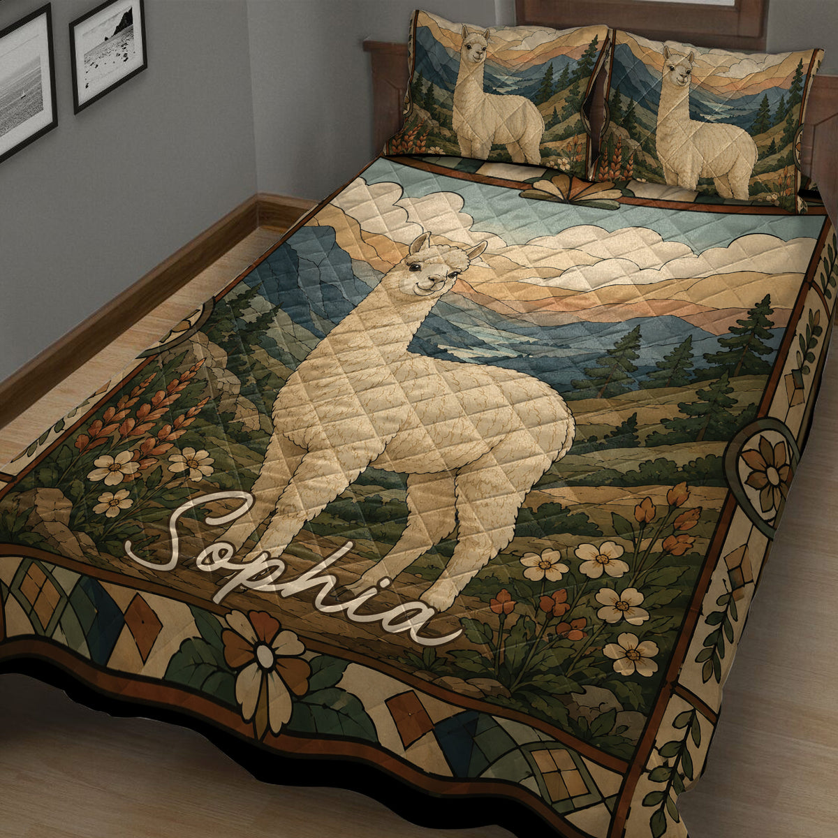 Alpaca quilt blanket spread across a bed with a detailed mountain landscape, flowers, pine trees, and alpaca artwork
