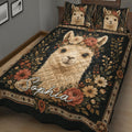 Close bedroom view of a dark floral alpaca quilt blanket with a large illustrated alpaca centerpiece
