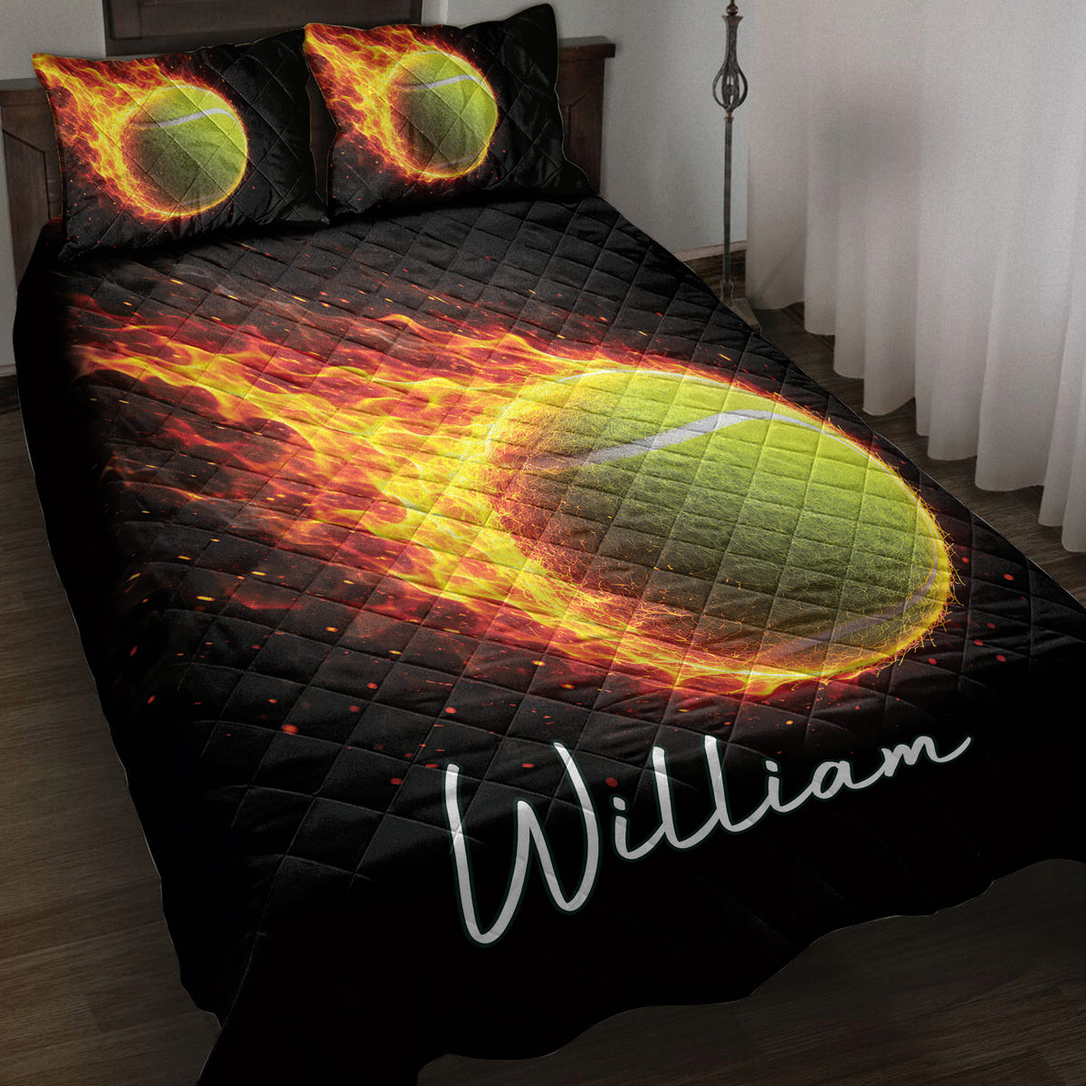 Tennis quilt blanket on a bed with a fiery tennis ball design in black, red, yellow and green