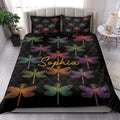 Bedroom styled with a black dragonfly quilt blanket and colorful dragonfly pillow artwork