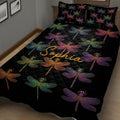 Black dragonfly quilt blanket displayed on a bed with vibrant multicolor dragonfly designs
