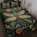 Dark botanical dragonfly quilt blanket displayed on a bed with floral artwork and coordinating pillow designs
