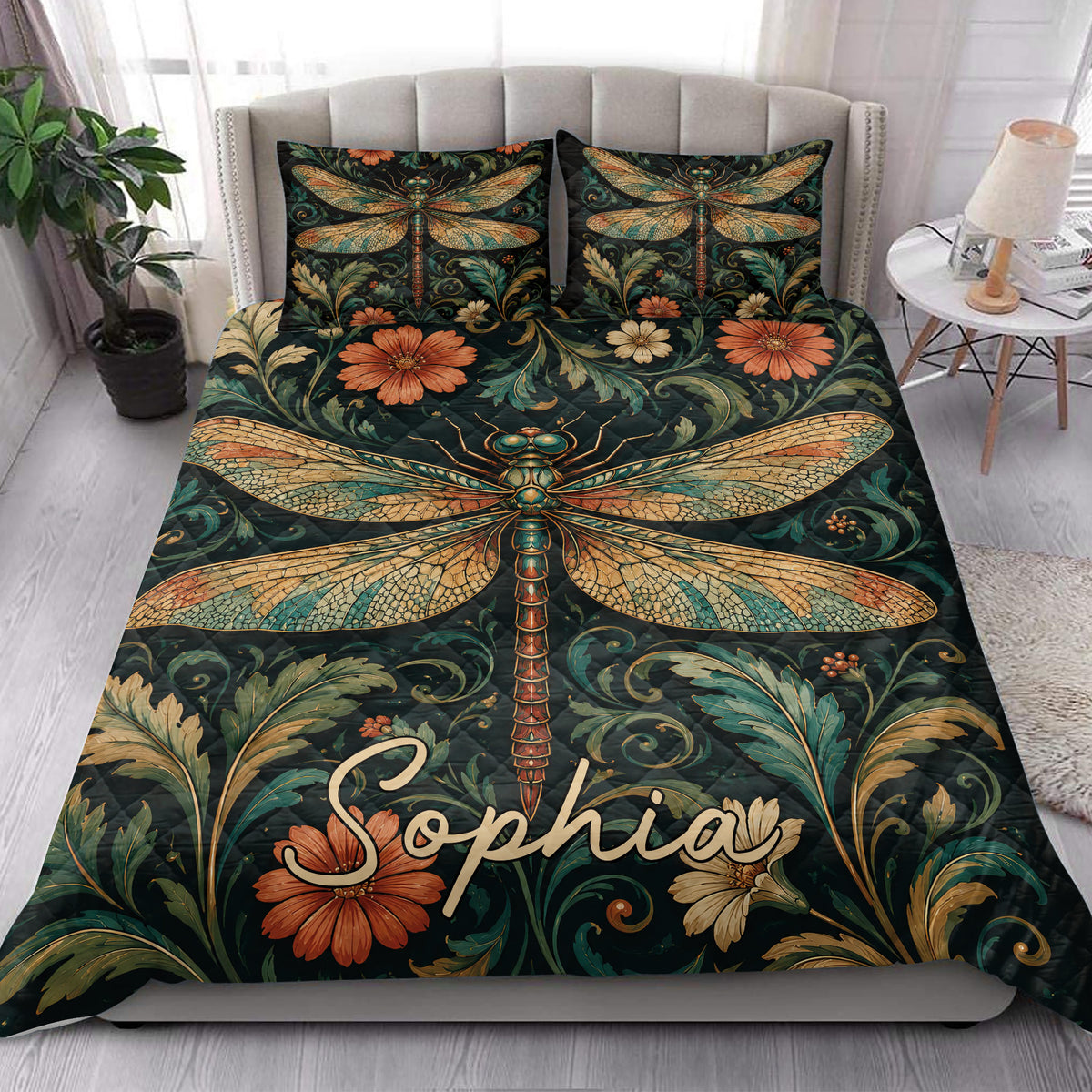 Dragonfly floral quilt blanket styled across a bright bedroom with matching decorative pillows
