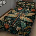 Close-up bedroom view of an ornate dragonfly quilt with teal foliage, flowers, and stained-glass inspired wings