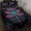 Black dragonfly quilt blanket with vivid pink, purple, and blue floral artwork on a bedroom