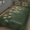 Close bedroom view of a green sheep quilt blanket with repeated pastoral animal artwork