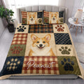 Corgi quilt blanket styled on a bed with matching Corgi artwork, plaid accents, and paw prints