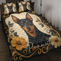 Miniature Pinscher quilt blanket displayed on a bed with floral borders and ornate black and gold artwork